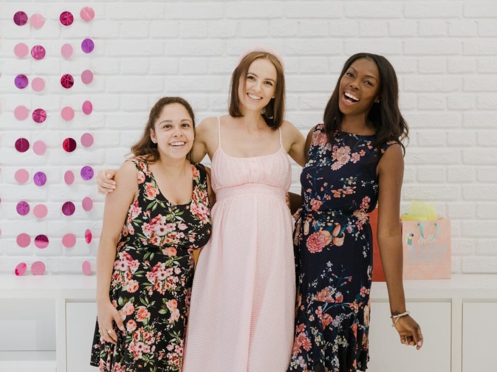 Expecting woman enjoying her time with her friends.