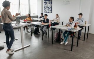Teacher in classroom with kids.