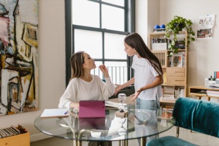 Mother and daughter seemingly having a discussion. Representing a child talking back to their mother.
