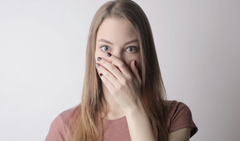 Woman covering her mouth with one hand