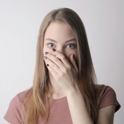 Woman covering her mouth with one hand