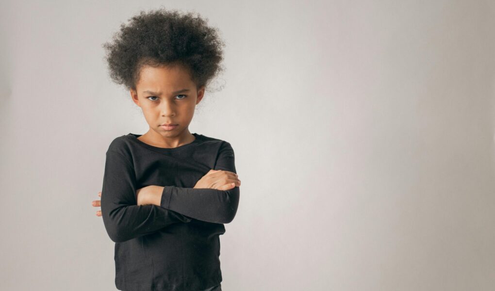 Upset child with arms crossed
