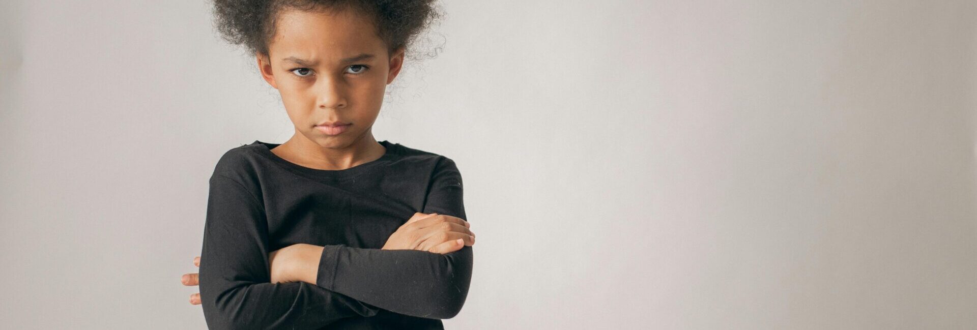Upset child with arms crossed