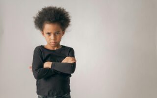 Upset child with arms crossed