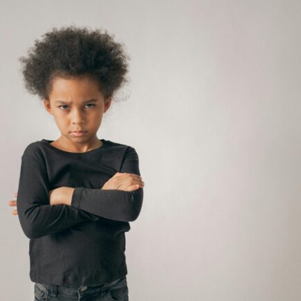 Upset child with arms crossed