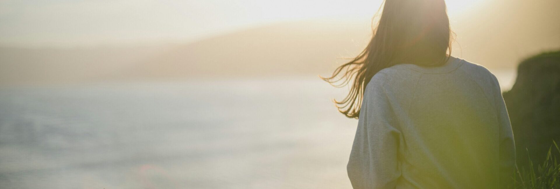 Woman looking out at sea from a high place.