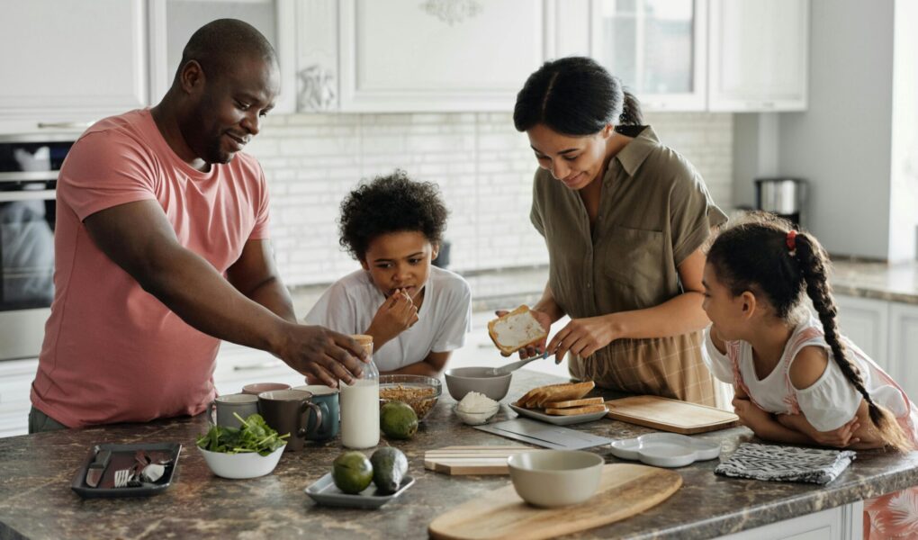 Family spending time together and preparing a meal.