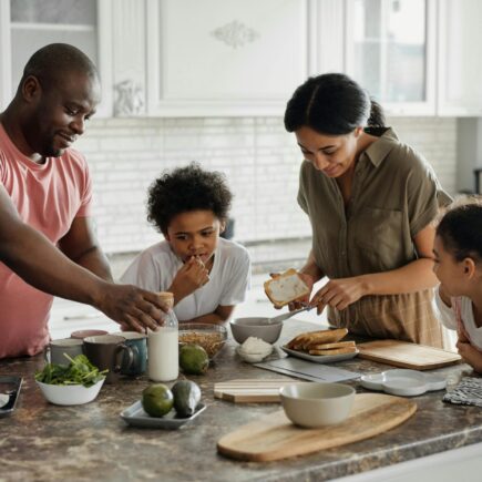 Family spending time together and preparing a meal.