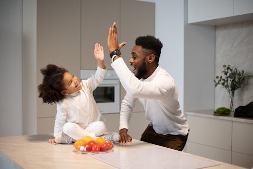 Father giving daughter a high five.