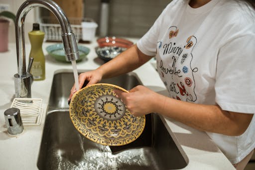 Woman washing dishes.