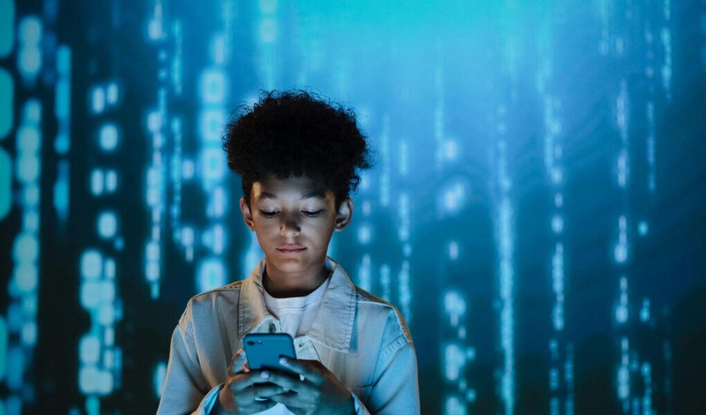 Boy looking down at his cellphone