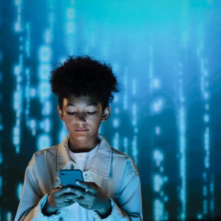 Boy looking down at his cellphone