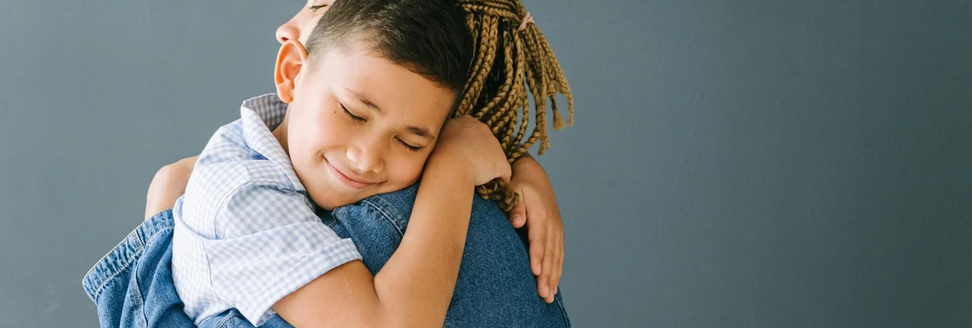 Mother and son hugging.